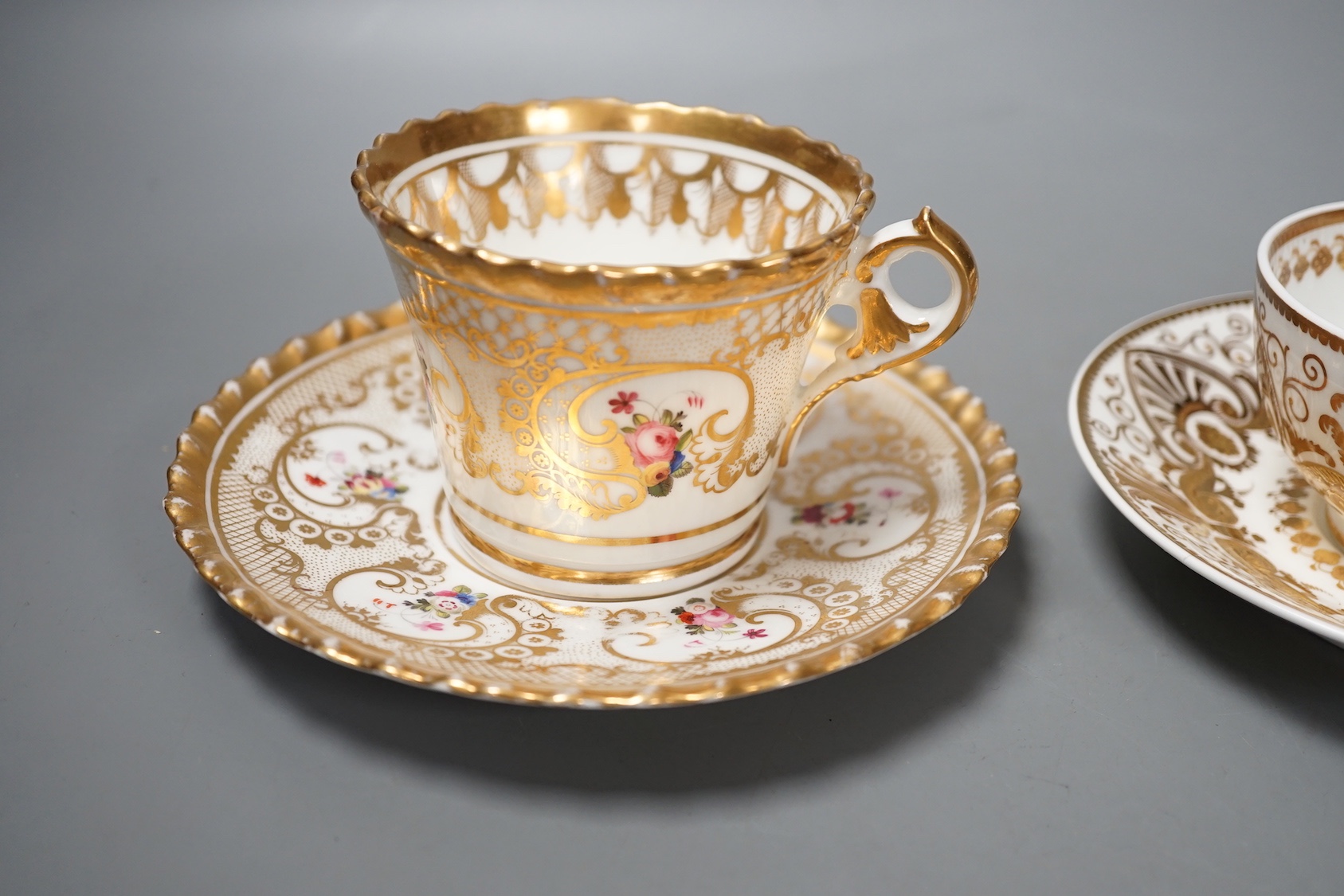 A Chamberlains Worcester gadroon bordered coffee cup and saucer painted with flowers, printed mark in puce and a Spode teacup and saucer with raised gilding in neo-classical style pattern 4327, mark and pattern in red